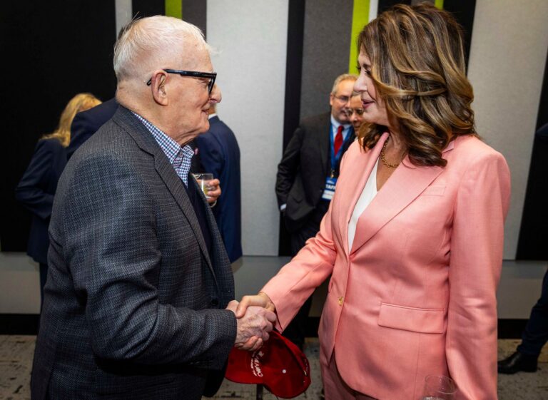 Danielle Smith shaking hands with a supporter
