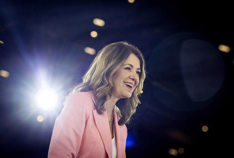Danielle Smith laughing on stage at the Calgary Leaders' Dinner