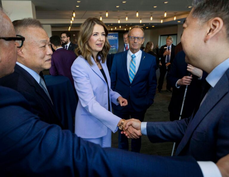 Danielle Smith shaking hands with supporters