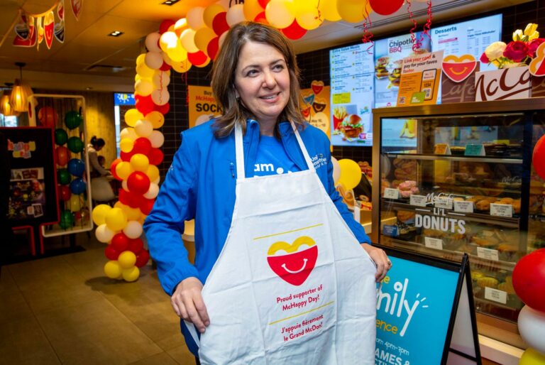 Danielle Smith in an apron volunteering behind a restaurant counter